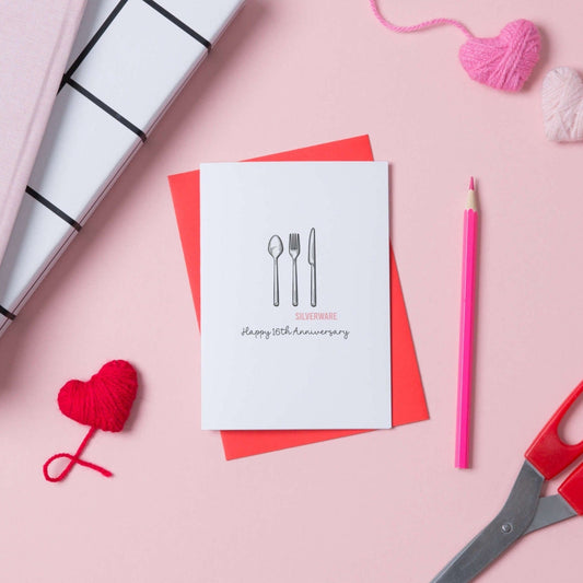 A 16th anniversary card with an illustration of a cutlery set with the words silverwear underneath. The card says Happy 16th Anniversary and comes with a red envelope.