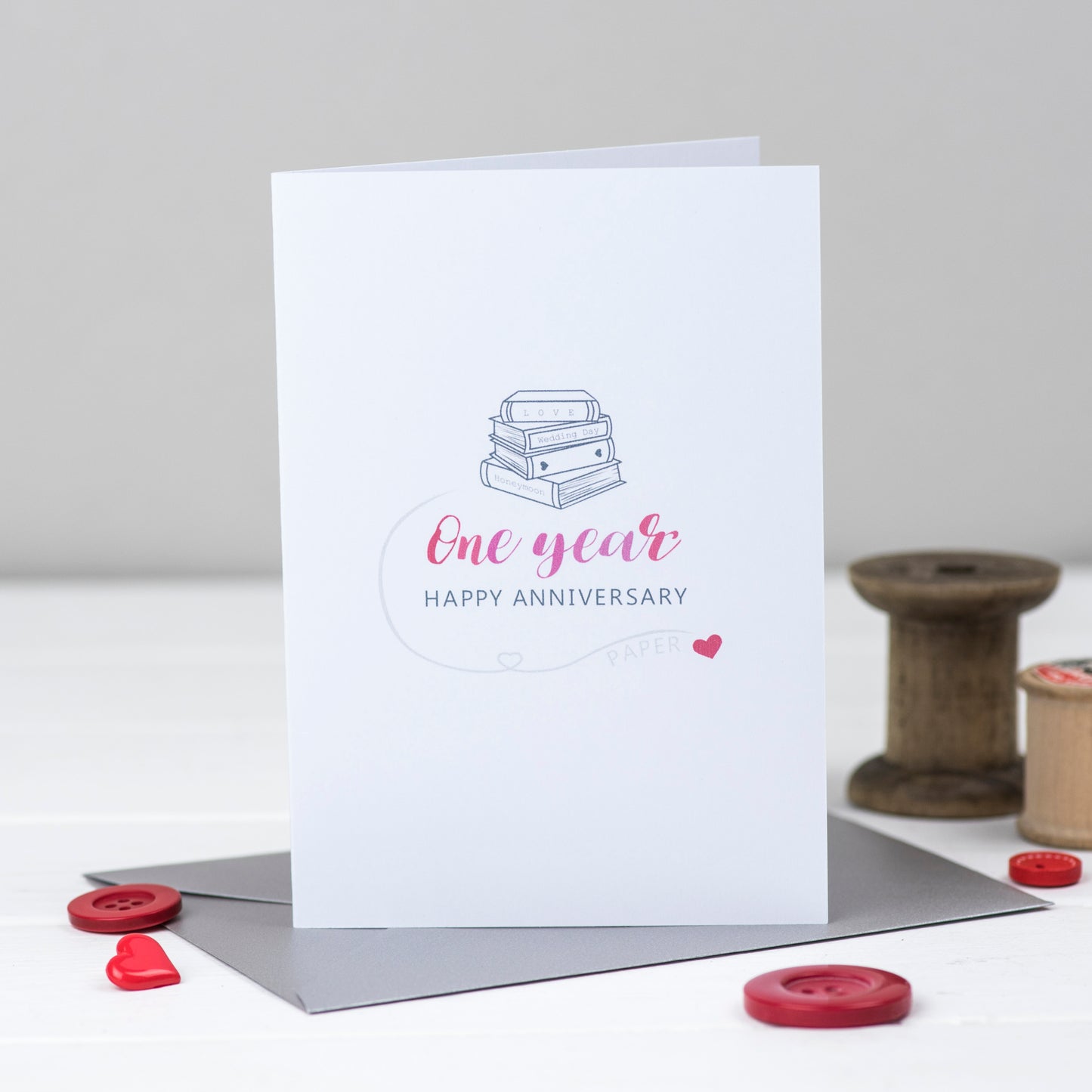 First Anniversary card with a stack of books