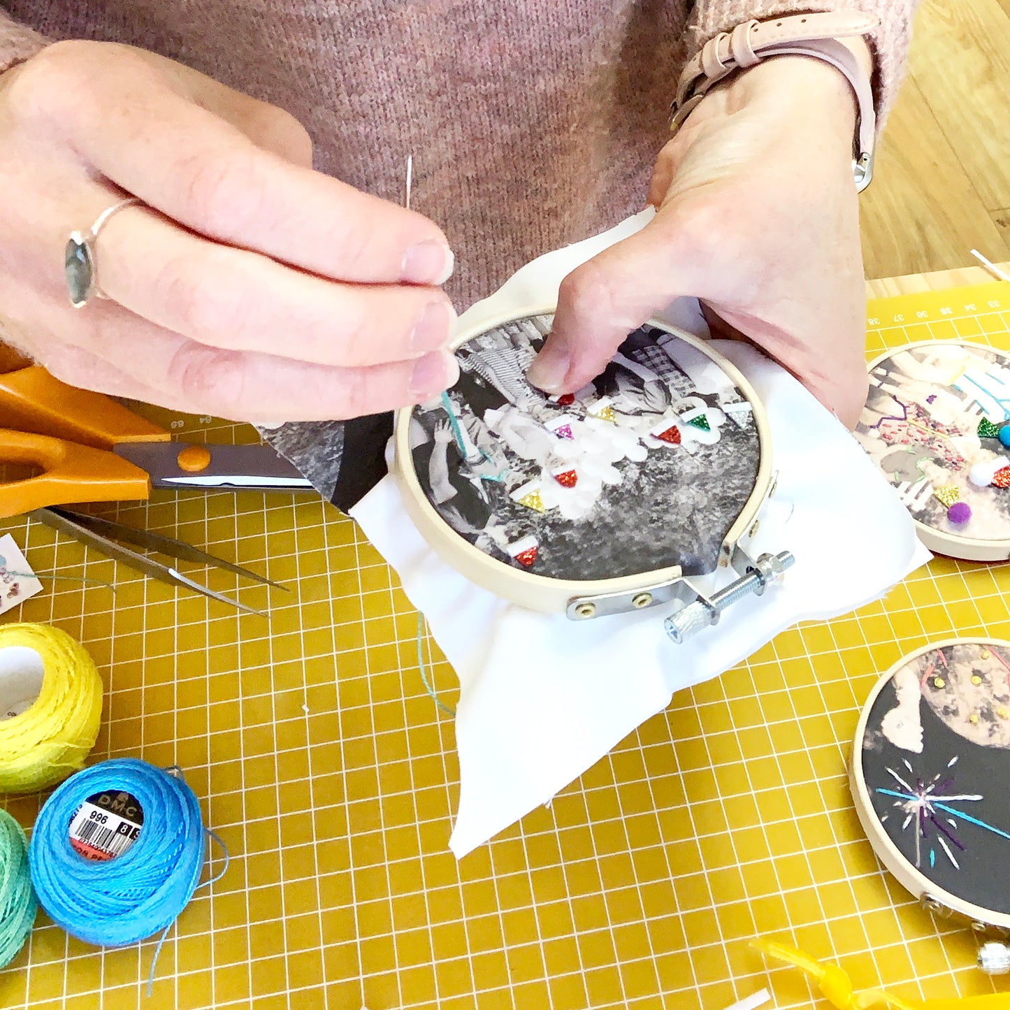 Embroidered photo gift being made. Photo is in an embroidery hoop and colourful stitches are being added to highlight the photo detail.