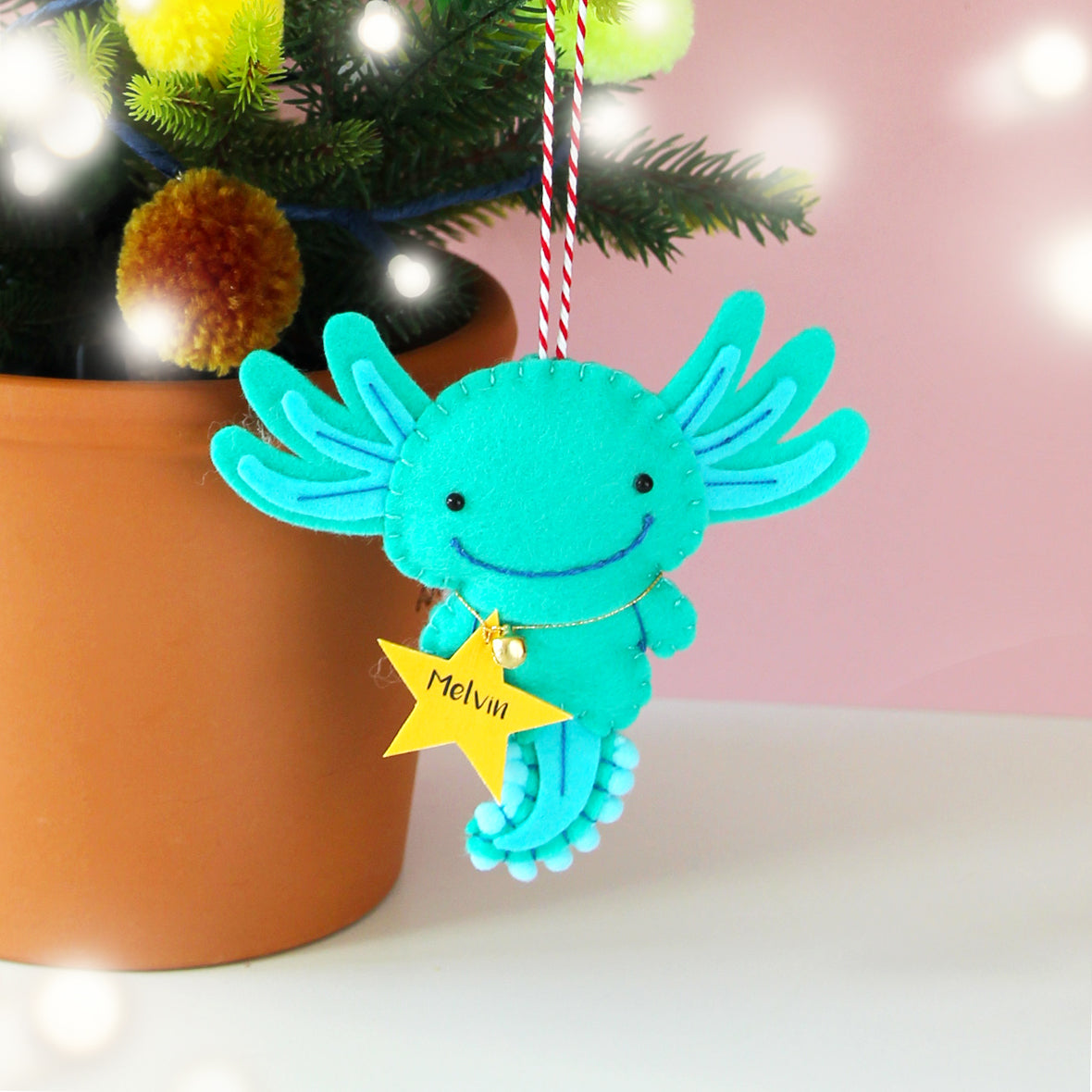 turquoise axolotl christmas tree decoration with a personalised star tag