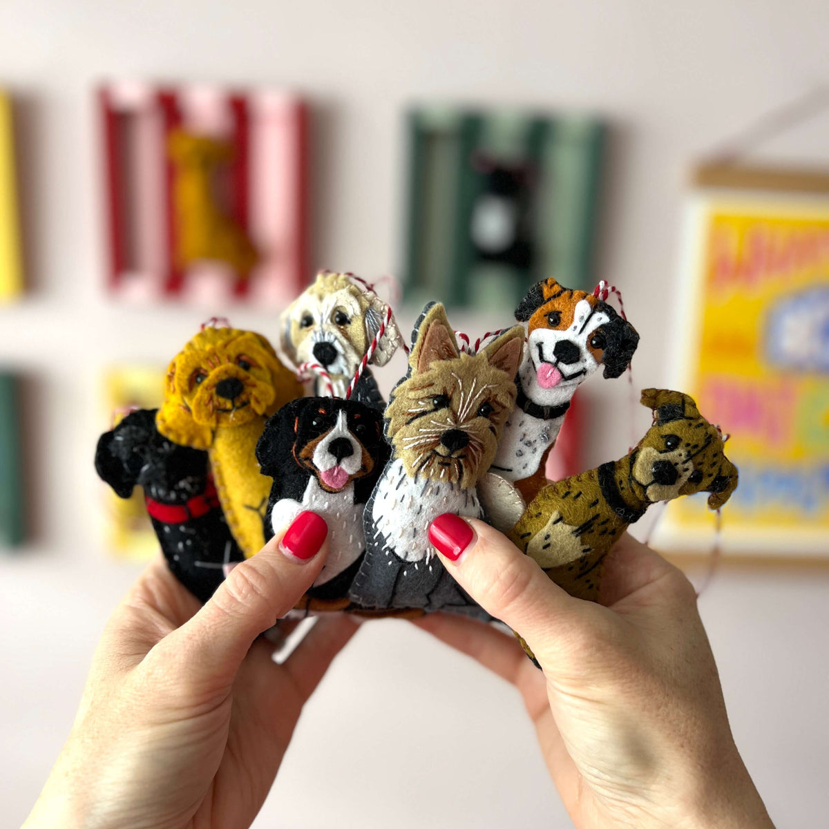 Hand holding a set of dog figurines with colorful background