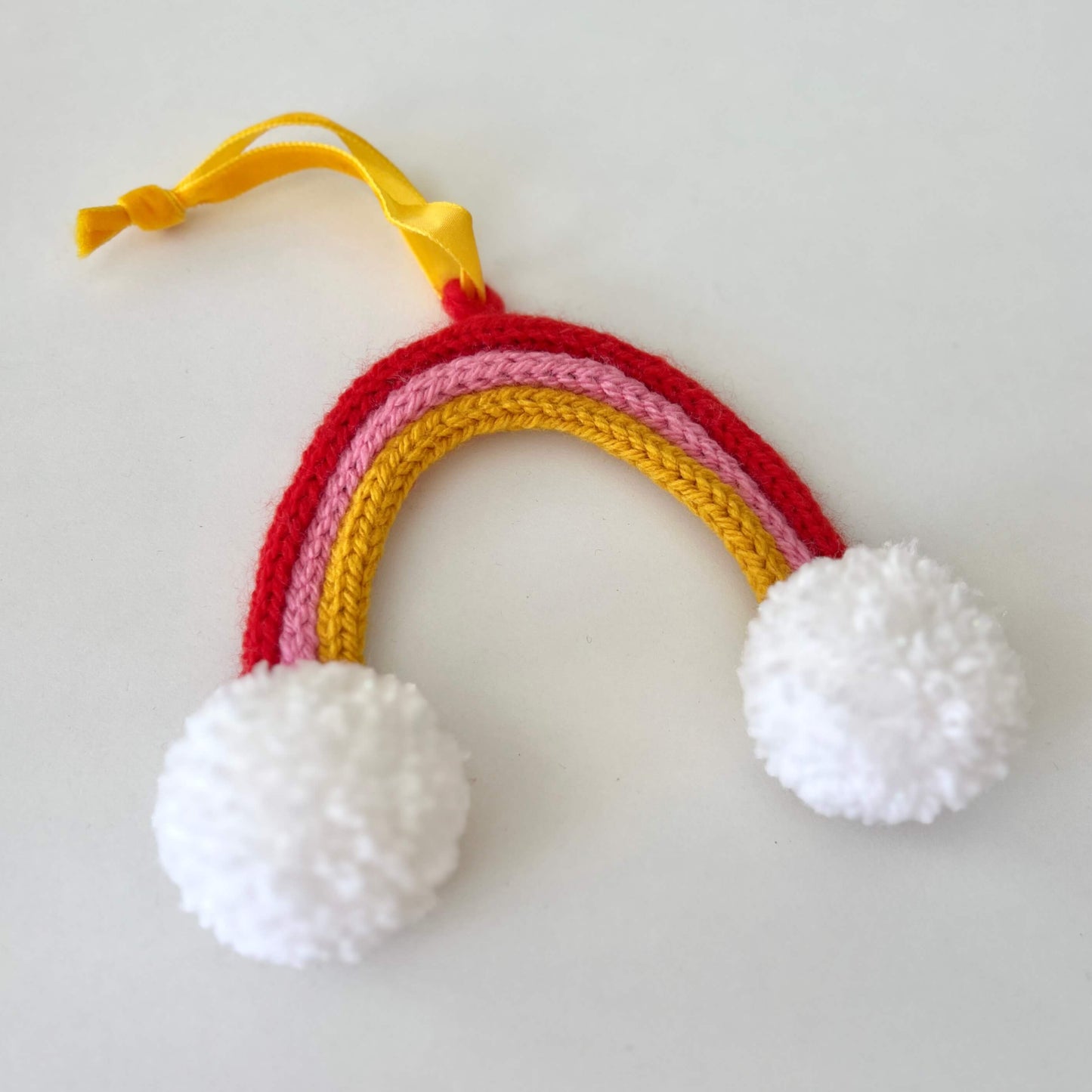 Knitted Rainbow - Pink, Red & Yellow with Pom Poms
