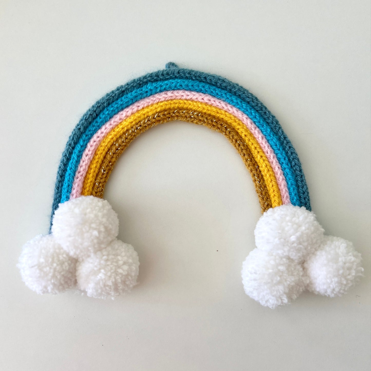 Knitted Rainbow - Blue, Pink, Yellow & Gold with Pom Poms.