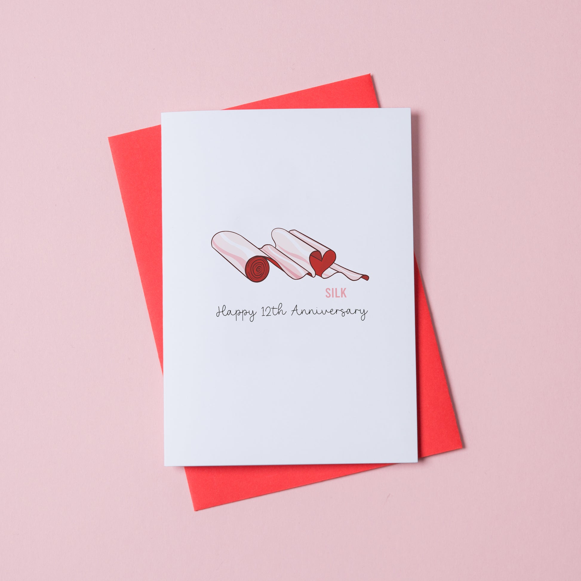 Silk anniversary card 12th year illustrated silk theme UK. A roll of silk material shaped in a heart.