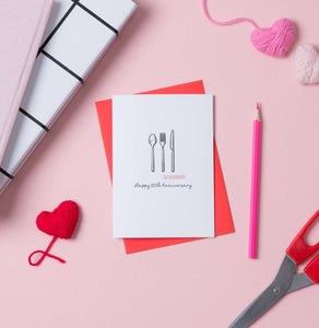 A 16th anniversary card with an illustration of a cutlery set with the words silverwear underneath. The card says Happy 16th Anniversary and comes with a red envelope.