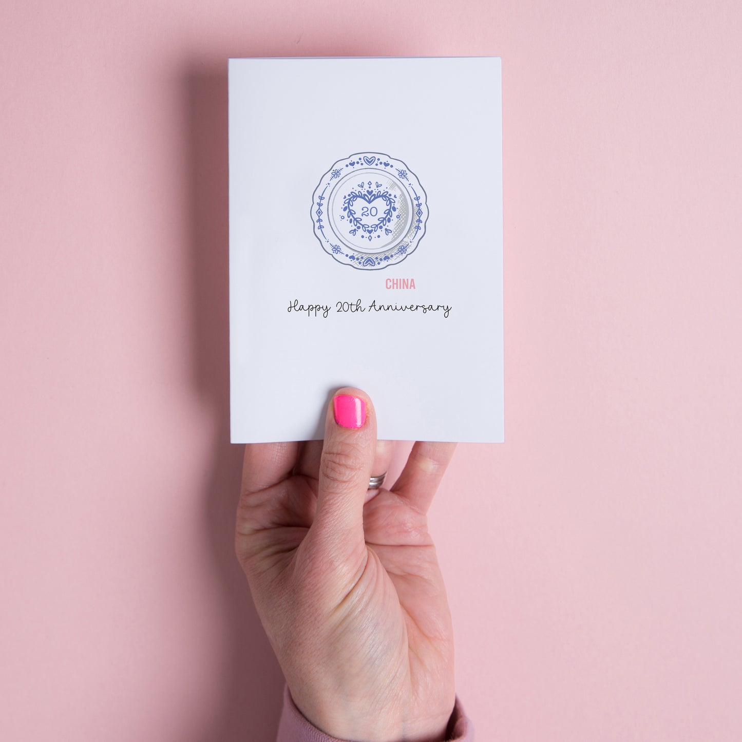 Card with a  china plate illustration with 20 in the middle to represent china, the traditional gift given for a 20th wedding anniversary.