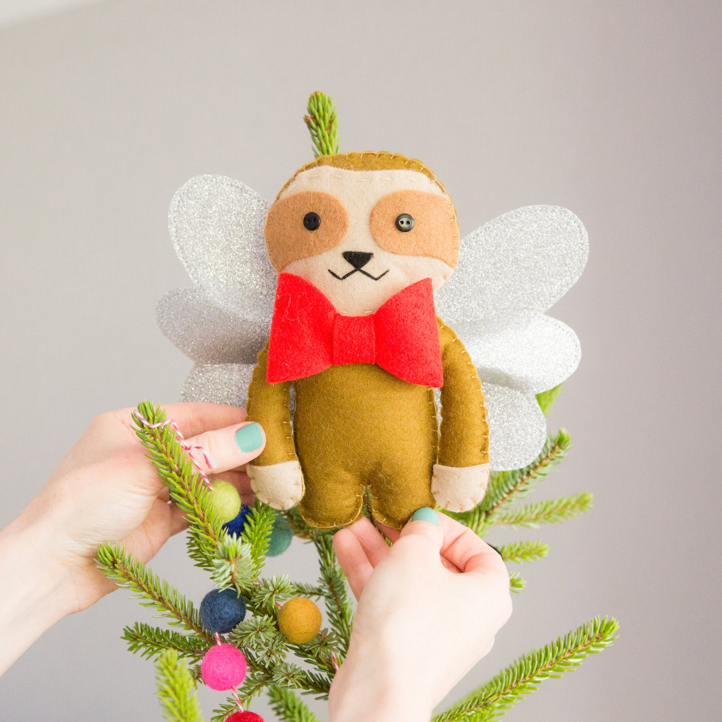 Sloth Christmas Tree Topper on top of tree