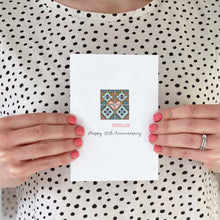 Load image into Gallery viewer, Someone holding a card with a illustration of porcelain tiles on the front.