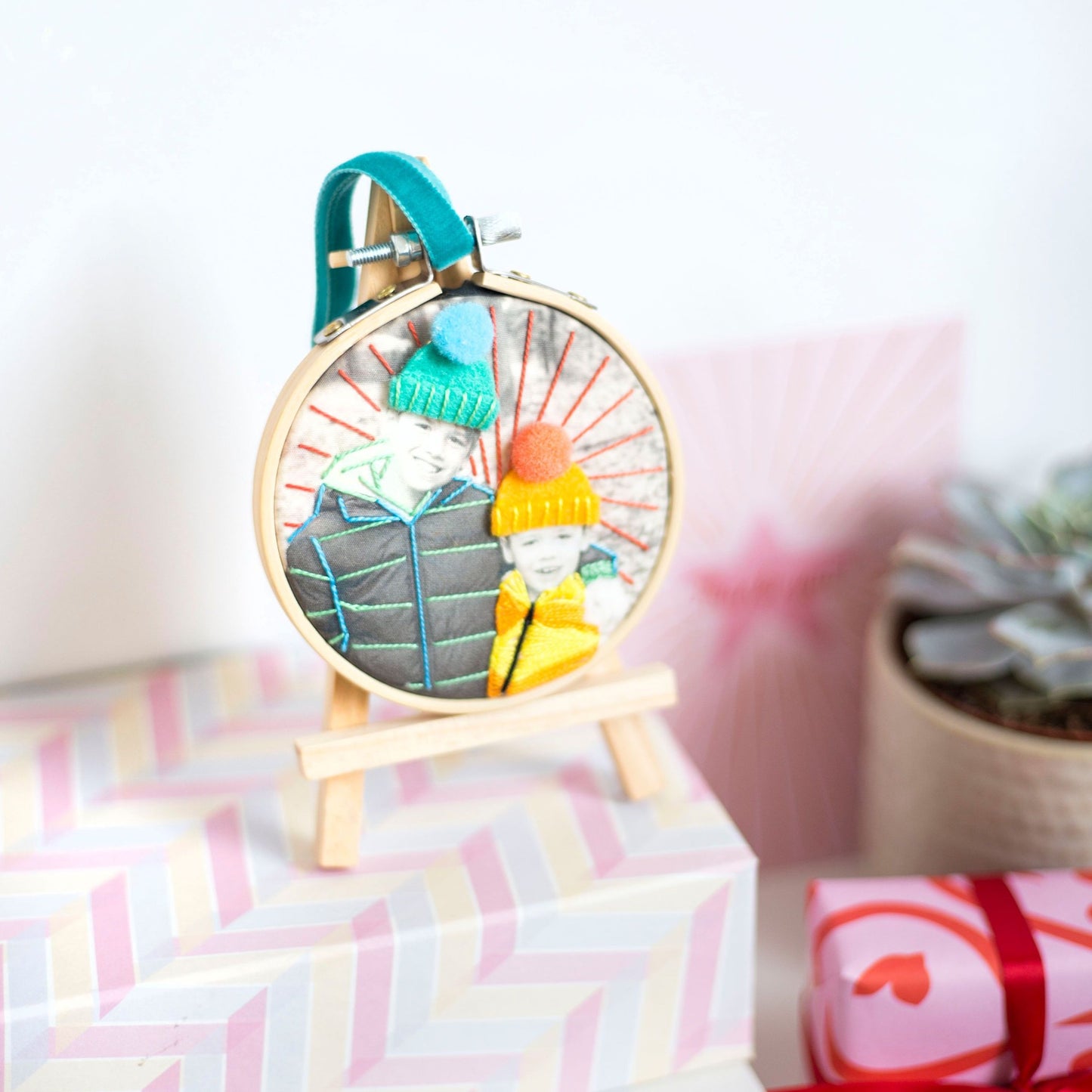 Close up detail of stitched photo hoop with bright thread and textures.