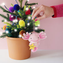 Load image into Gallery viewer, pink axolotl christnas tree decoration being hung on a Christmas tree